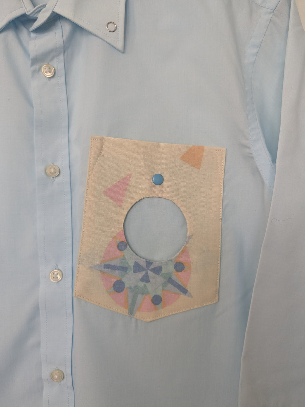 Upcycled cropped light blue shirt with a cool geometric pocket