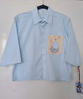 Upcycled cropped light blue shirt with a cool geometric pocket
