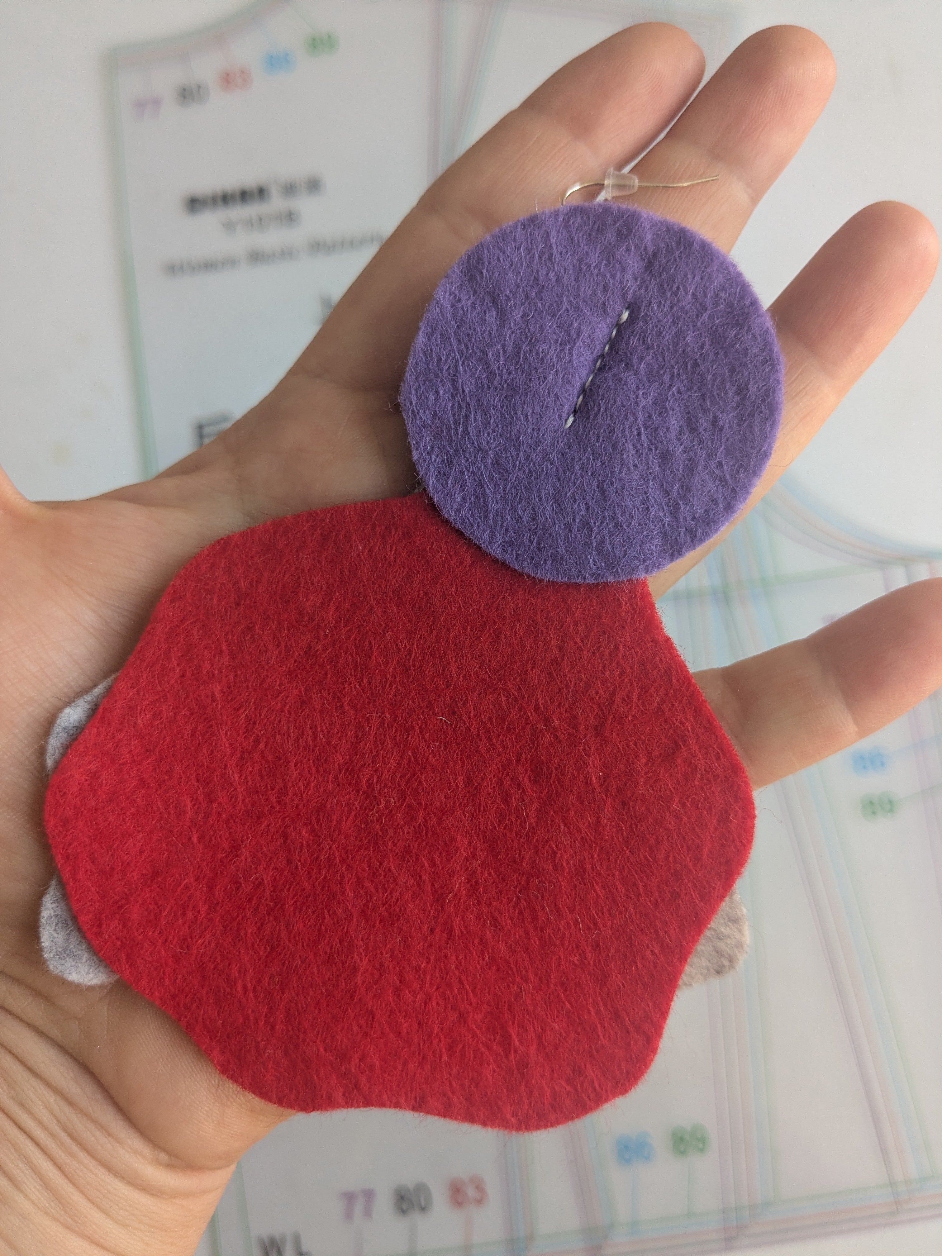 Single abstract felt earring in red, orange, purple and grey