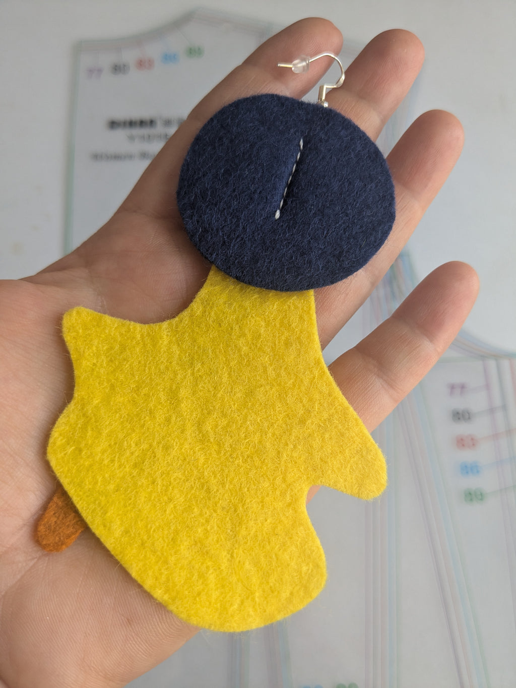 Single abstract felt earring in yellow, green, grey, navy and orange